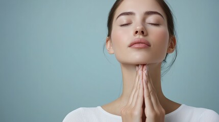 Woman with closed eyes in tranquility, hands clasped subtly in prayer, serene expression, soft lighting.