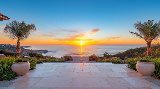 Oceanfront walkway with stone tiles and palm trees, leading towards a beach sunset