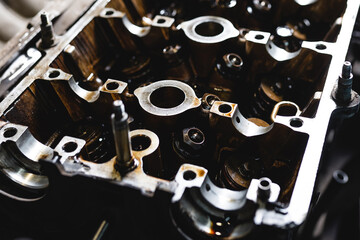 Disassembled car engine in oil. Cylinder head of an automobile e