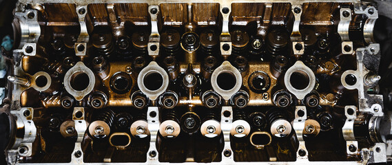 Disassembled car engine in oil. Cylinder head of an automobile engine. Inside the car being...