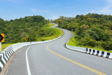 Popular view point of double s-curve road up to the hill with green tree and sky, called curve number 3 at Nan province, Northern of Thailand