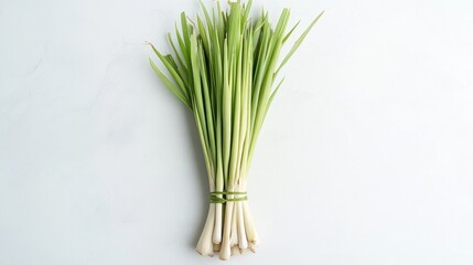 Fototapeta premium Bunch of Fresh Lemongrass Stalks on a White Surface