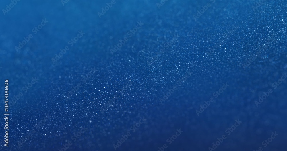Poster a deep blue background covered with densely packed shimmering particles, creating a textured surface