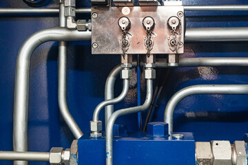 High pressure hydraulic hose system connected to steel pipes, close-up. Marine hydraulics.