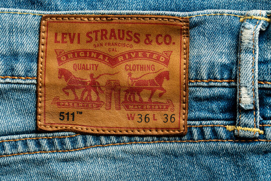 Levi's Strauss blue jeans with brand leather tag. Levi Strauss is an American clothing company, selling classic vintage denim jeans. Classic Levis jeans label, closeup