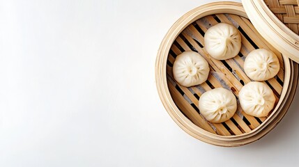 A clean, top-down view of a bamboo steamer filled with freshly cooked baozi (Chinese steamed buns) on a white background, emphasizing traditional Chinese flavors.