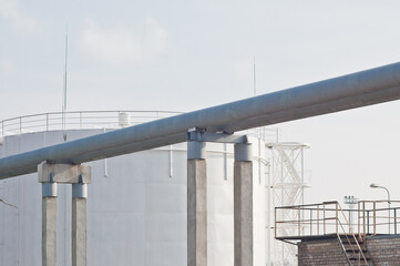 Fototapeta premium The photo shows a pipeline and a fuel storage tank