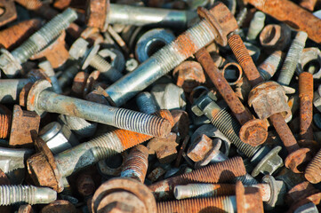 The photo shows old rusty bolts and nuts close-up