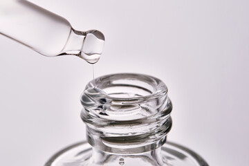 Close-up of a cosmetic bottle with a pipette showing the texture of the serum.