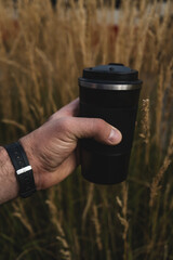 hand holding a cup autum