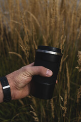 hand holding a cup autum