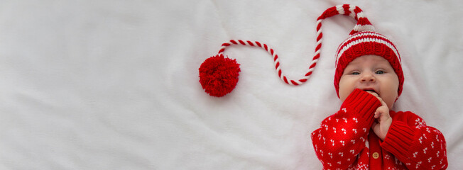 baby, little girl dressed as Santa Claus. holiday