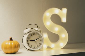 halloween pumpkin and white clock