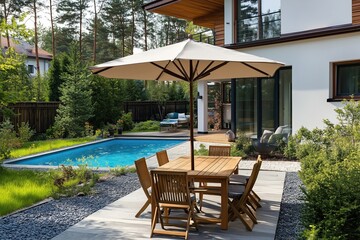 Obraz premium A patio with a pool and a large umbrella