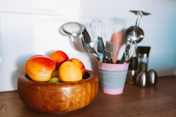 Kitchen utensils or cooking tools in iron decorative bucket, on kitchen wooden surface. Kitchen utensils collection