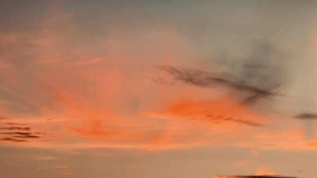 Beautiful sky during sunset or sunrise. The clouds are a perfect blend of warm orange and soft pink. The gradient makes this scene look calm and peaceful.