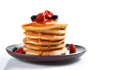 Pancakes with syrup on top on side position provides copy space for text. background concept isolated white