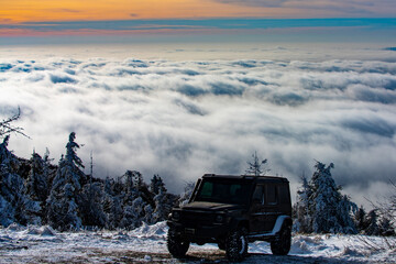 Off road in snow on the mountains. Offroad vehicle in winter snow. Off road vehicle in the winter forest, drift in the snow. SUV Off road in a Snowstorm. Cars off-roads trip, winter offroad track. © Volodymyr