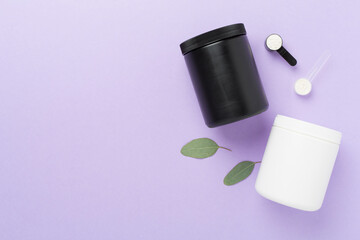 Jars with protein powder on color background, top view. Sports nutrition concept