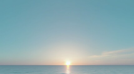 Obraz premium The sky is blue and the sun is setting. The water is calm and the horizon is visible