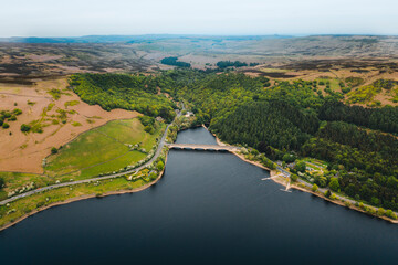 Fototapeta premium Aerial view wtih beautiful green landscape Derwent Dam, snake road bridge Peak District