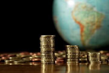 saving coins with money to pay bills having the intention of calculating raising more money to be...