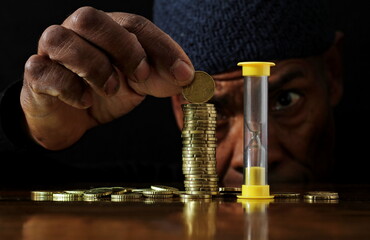 saving coins with money to pay bills having the intention of calculating raising more money to be...