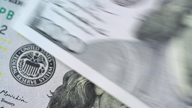 Closeup examination of US hundred dollar banknotes, showcasing its features