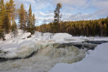 Winter landscape with a waterfall and snow. Russia, Karelia