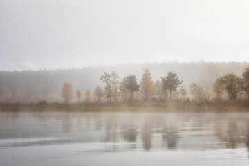 Beautiful autumn landscape with the fog and river . Russia