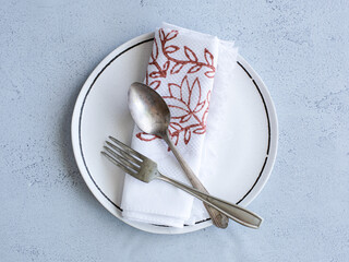 plate with cutlery on table top