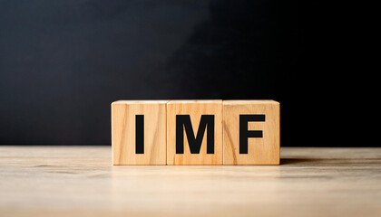 Wood cubes with abbreviation text IMF on wooden table. International Monetary Fund.