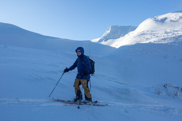 A moment of solitude: a skier enjoys the peaceful beauty of a winter landscape.