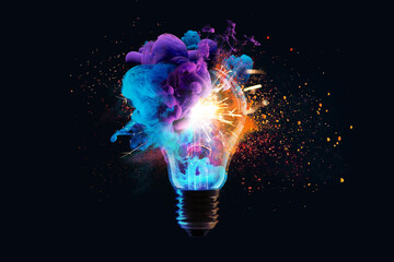 Creative light bulb explodes with colorful dry paint, sparks and splashes on a black background,...