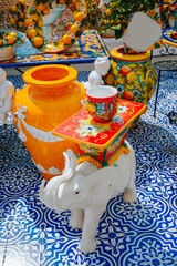 Colorful traditional Italian ceramics with lemon motifs and decorative vases on display in...
