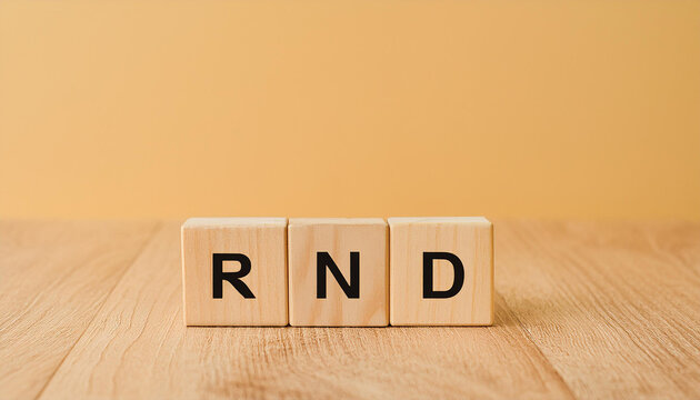 Wood cubes with abbreviation text RND on wooden table. Research and Development. Close-up.