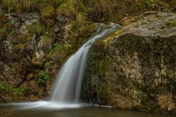 Naklejka premium Small waterfall near Jaworki village of Biala Woda creek in autumn day