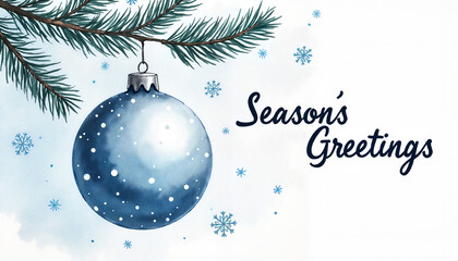 Blue Christmas ornament hanging on pine branch with snowflakes