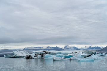 Blue block of ice in the water