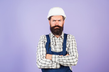 Serious funny builder worker. Handyman builder in hardhat. Building concept. Builder foreman. Man...
