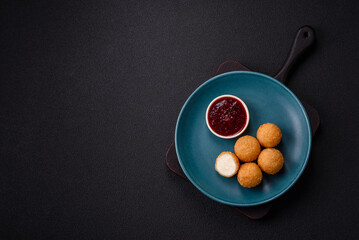 French fries balls with breaded brie or camembert cheese with sweet berry sauce