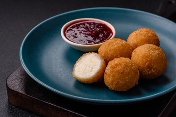 French fries balls with breaded brie or camembert cheese with sweet berry sauce