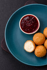 French fries balls with breaded brie or camembert cheese with sweet berry sauce