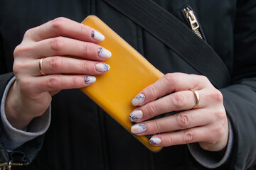 Stylish fashionable manicure of hands woman, pearlescent manicure with a pattern