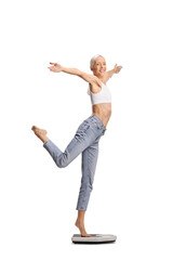 Young female dancer weighing on a scale