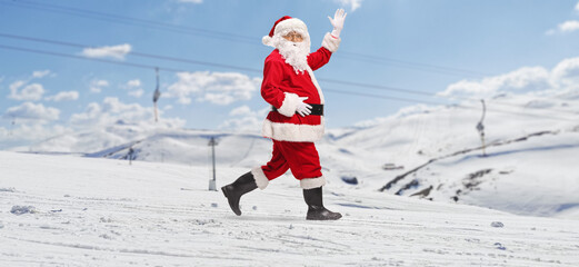Santa Claus walking on a snowy mountain
