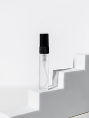 Small bottle of spray with perfume sample on white background. Small package