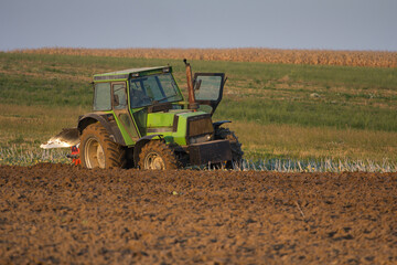 Agriculture machinery in action a tractor plows a field on a bright day © Bagatela