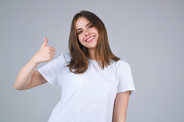 Like concept. Choice Feedback. Woman Hand with Thumbs up, like, good and yes. Girl with Like finger sign on gray studio. Hand icon. Female Hand sign thumbs up yes like concept.