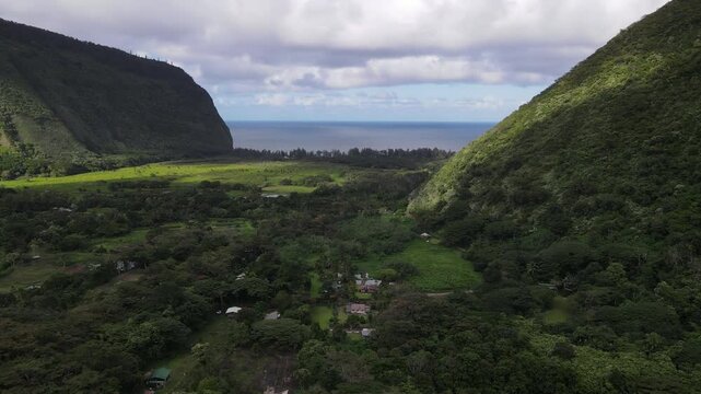 Aerial view of the Waipio Valley on the Big Island of Hawaii with its beautiful waterfalls shrouded in fog and clouds.